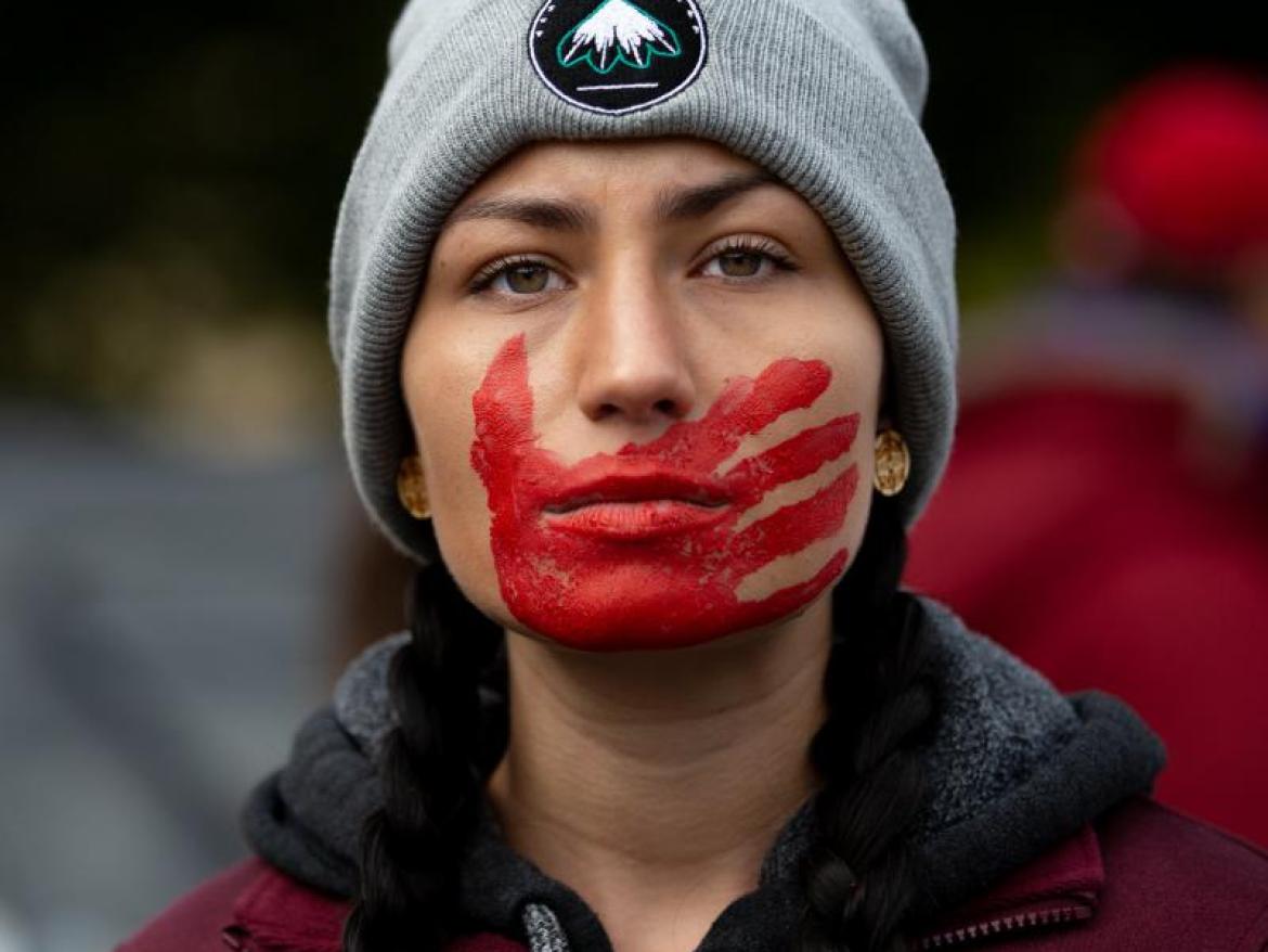 Woman with red handprint on her face